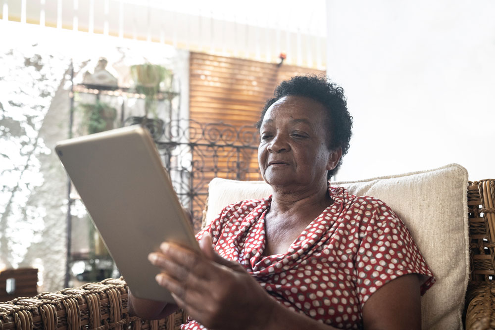 Older woman using a tablet at home