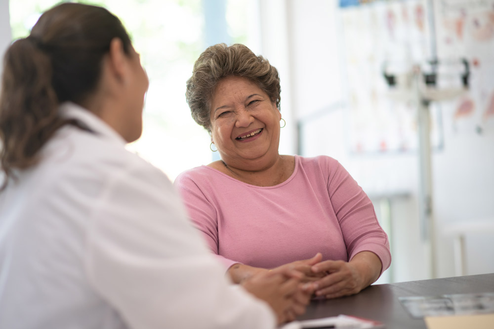 Doctor talking with elderly patient